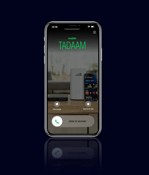 Smartphone showing an incoming call from TADAAM with a device in the background.