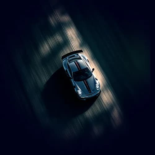 A sports car seen from above, driving fast on a road.