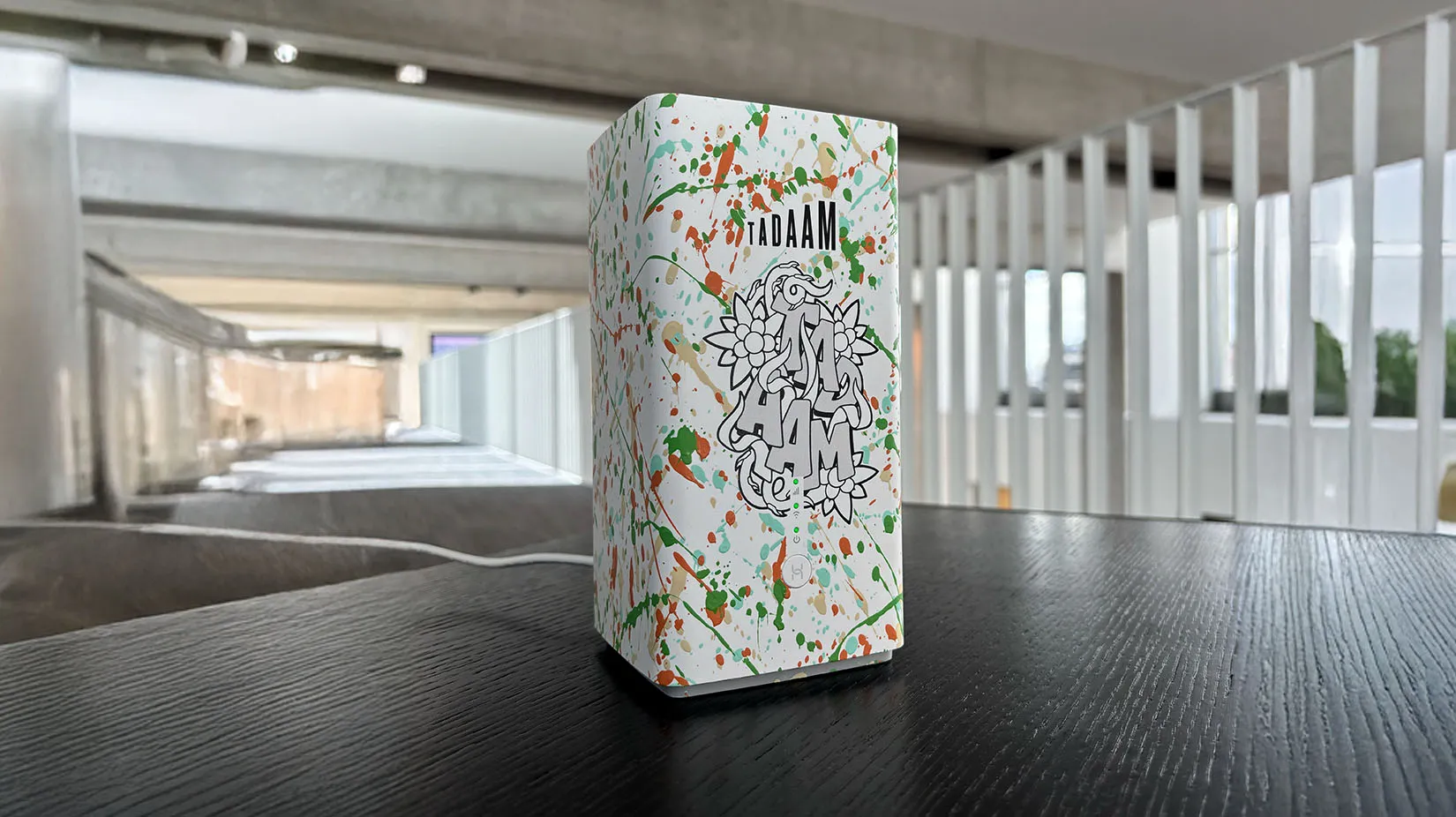 A TADAAM art modem standing on a table.